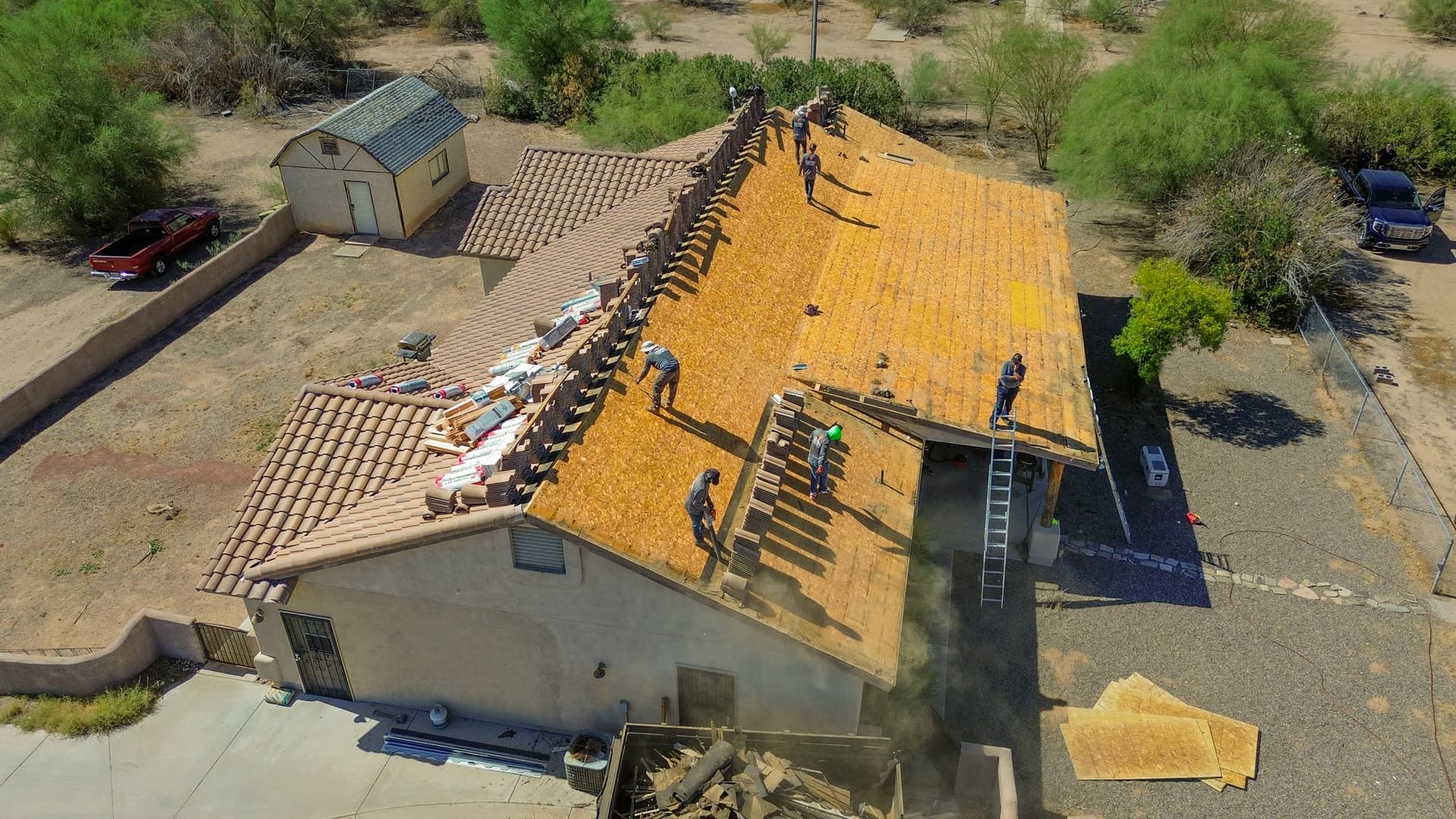 Aerial view of a Vizcom Contracting crew replacing the tile roof on a Phoenix home.