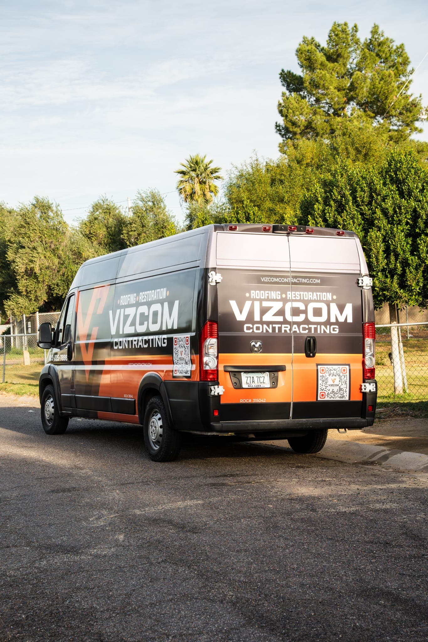 A wrapped Vizcom Contracting van parked outside a Phoenix home.